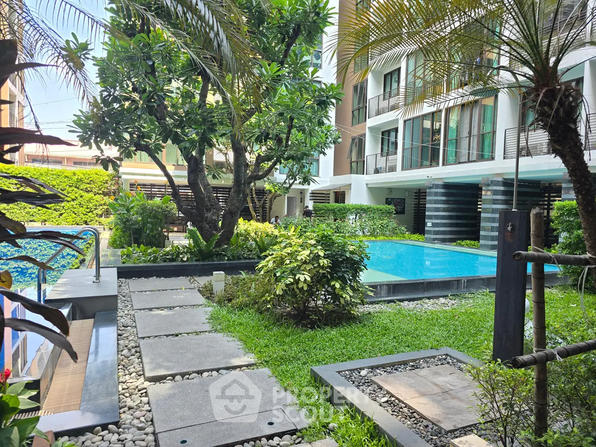 Luxurious condominium with lush garden and inviting swimming pool