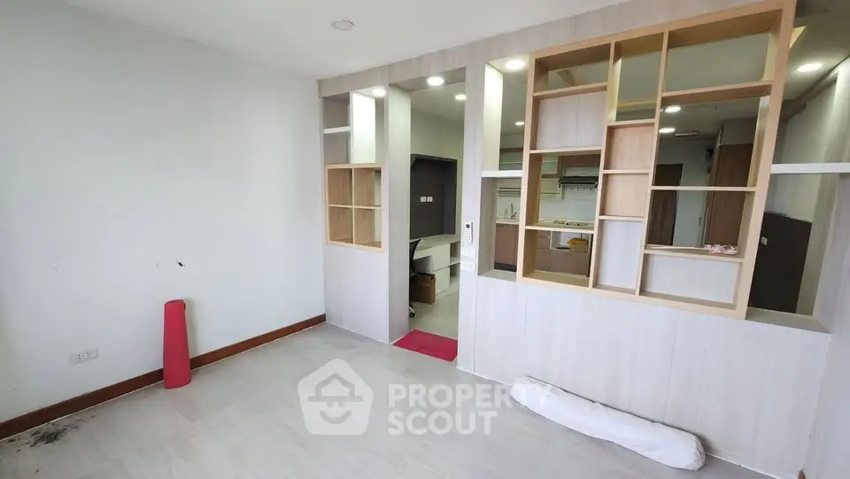 Modern open-layout living space with stylish partition and kitchen view