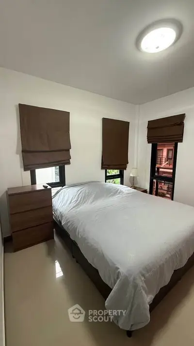 Cozy bedroom with modern furnishings and natural light