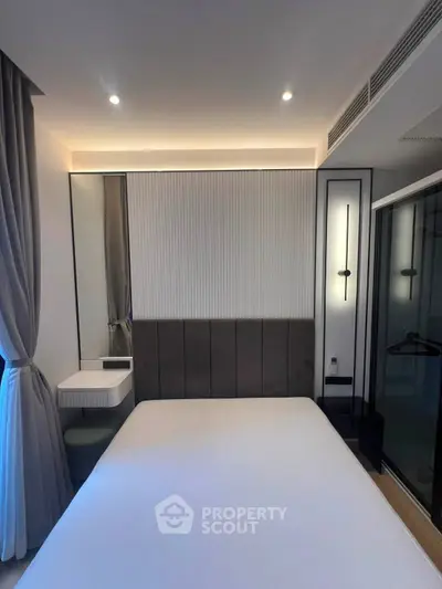 Modern bedroom with sleek design and ambient lighting, featuring a cozy bed and stylish decor.