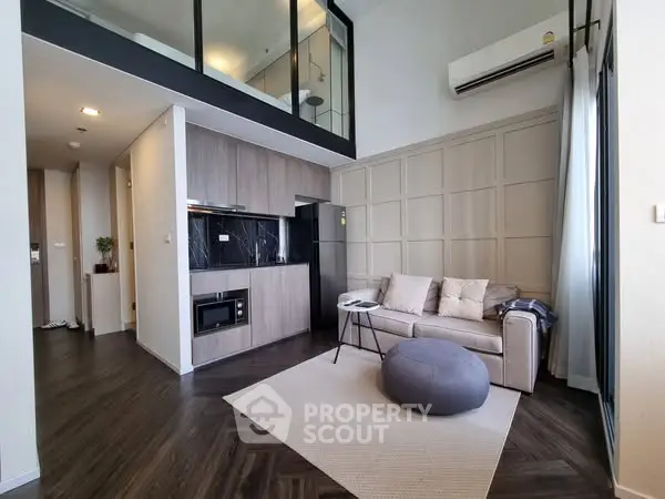 Modern loft-style living room with mezzanine and sleek kitchen design