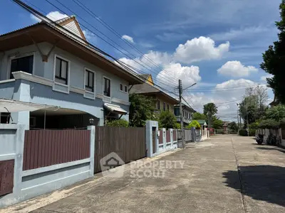 Charming suburban street with modern houses and clear blue sky