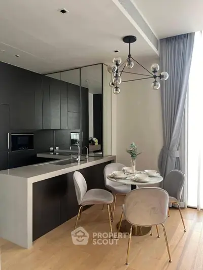 Modern kitchen with sleek black cabinets and elegant dining area