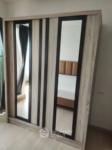 Modern bedroom with stylish mirrored wardrobe and elegant bed