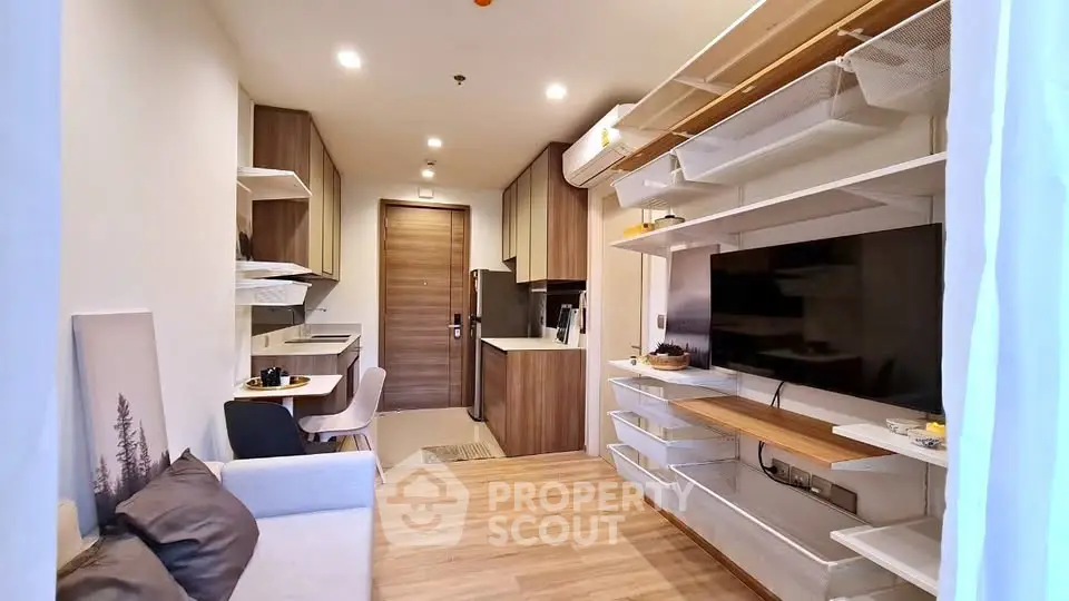 Modern living room with open kitchen layout and stylish wooden accents