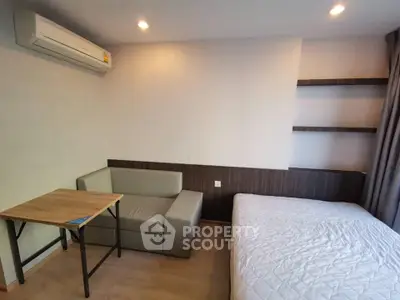 Cozy studio apartment with modern furnishings and ample natural light, perfect for urban living.