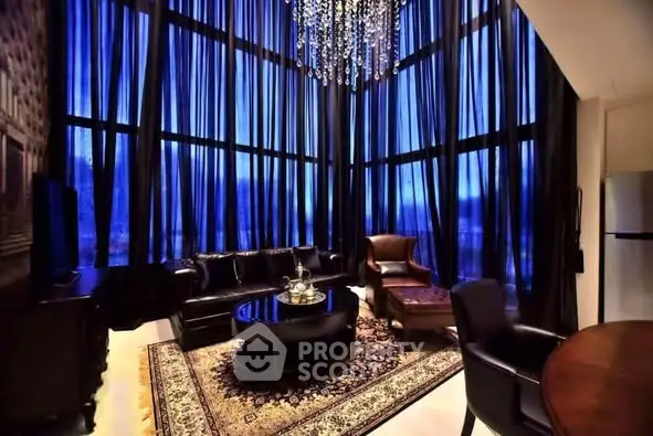 Luxurious living room with high ceilings and elegant chandelier