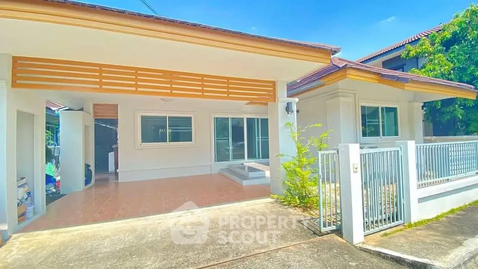 Charming single-story home with spacious driveway and modern exterior design.