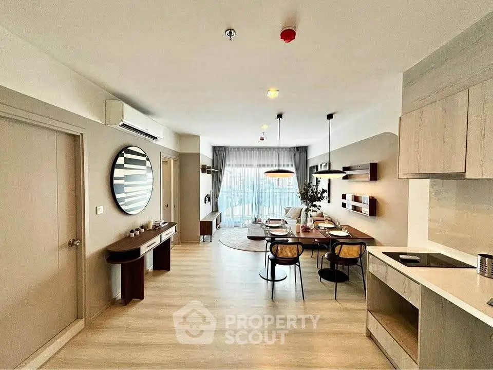 Modern open-plan living and dining area with stylish decor and natural light.