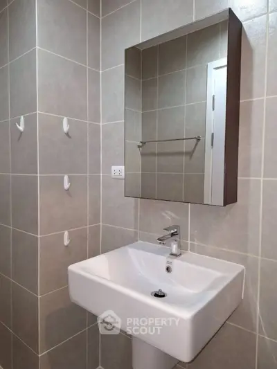 Modern bathroom with sleek sink and wall-mounted mirror cabinet