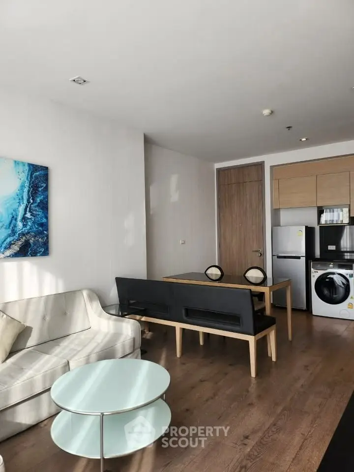 Modern living room with stylish furniture and kitchen appliances