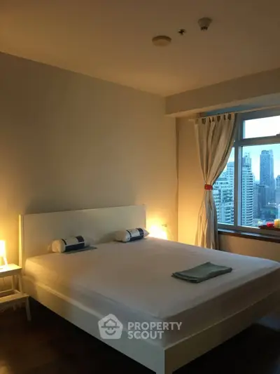 Modern bedroom with city view, featuring a minimalist design and large window.