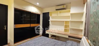 Modern bedroom with built-in shelves and sleek wardrobe design