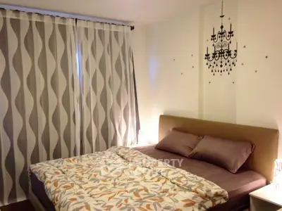 Cozy bedroom with elegant chandelier decal and stylish curtains, perfect for restful nights.