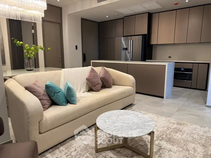 Luxurious modern living room with open kitchen, elegant sofa, and stylish decor