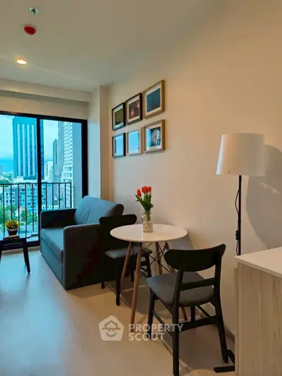 Modern living room with city view, cozy seating, and stylish decor in a high-rise apartment.