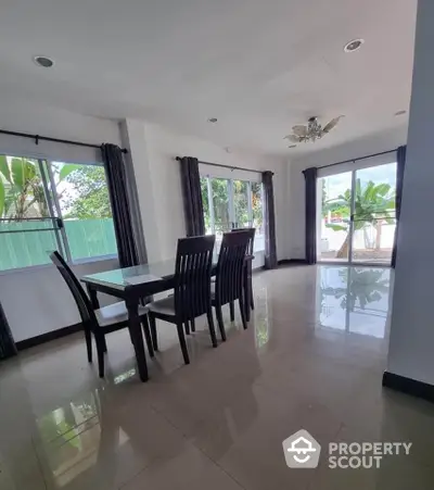 Spacious dining area with large windows and elegant decor