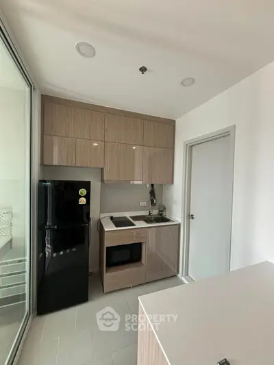 Modern compact kitchen with sleek cabinetry and appliances