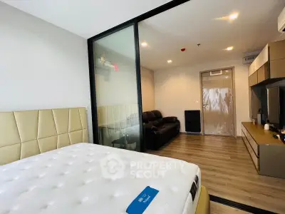 Modern apartment interior with spacious bedroom and cozy living area, featuring sleek design and ample natural light.