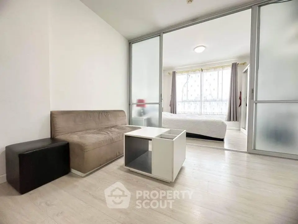 Modern studio apartment with frosted glass partitions and natural light