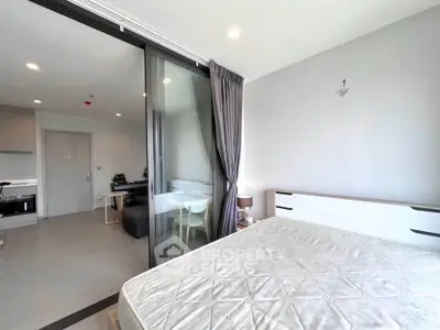 Spacious modern bedroom with sliding glass doors and natural light