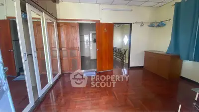 Spacious bedroom with wooden flooring and ample closet space