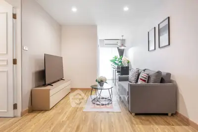 Modern living room with sleek furniture and natural light, perfect for relaxation and entertainment.