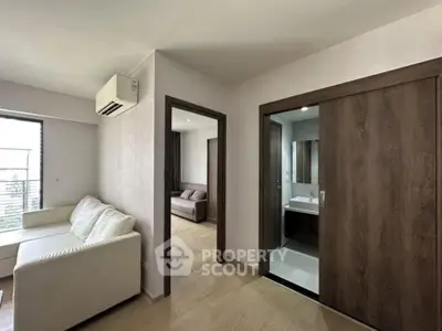 Modern apartment interior with cozy living room and sleek bathroom design.