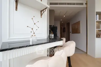 Modern kitchen with marble countertop and elegant bar stools in a stylish apartment