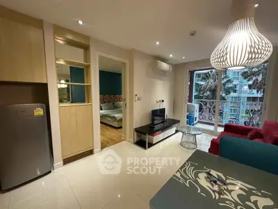 Modern living room with stylish decor and balcony view in a contemporary apartment.