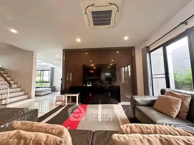 Spacious modern living room with sleek design and large windows for natural light.