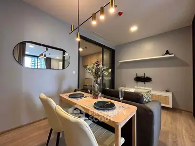 Modern living room with stylish dining area and elegant lighting in a contemporary apartment.