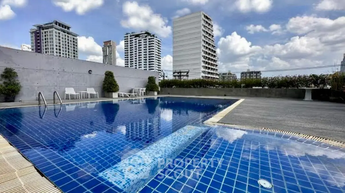 Stunning rooftop pool with city skyline views, perfect for relaxation and leisure.