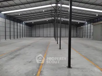 Spacious industrial warehouse with high ceilings and ample storage space.