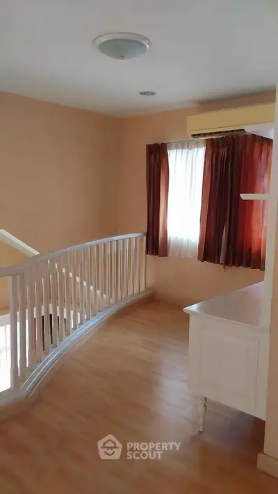 Spacious interior with elegant wooden flooring and natural light, perfect for a cozy home atmosphere.