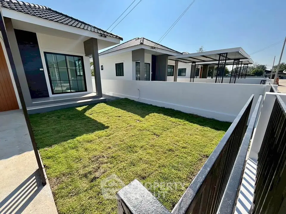 Charming modern house with lush green lawn and sleek exterior design, perfect for family living.
