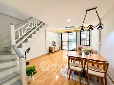 Spacious modern living room with elegant dining area and stylish staircase