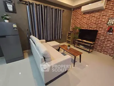Stylish living room with modern decor, featuring a cozy sofa, TV, and air conditioning.