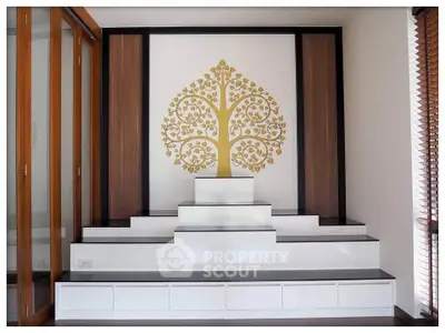 Elegant interior with modern built-in shelving and decorative wall art in a stylish living space.