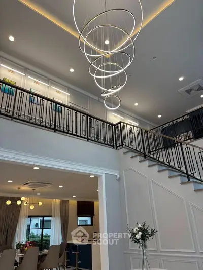 Luxurious modern living room with elegant staircase and stylish lighting