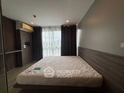 Modern bedroom with large window and stylish decor