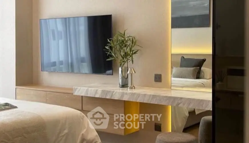 Modern bedroom with sleek TV setup and elegant decor