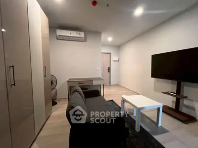 Modern living room with sleek furniture and wall-mounted TV