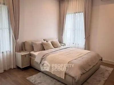 Elegant bedroom with cozy bed and soft lighting, perfect for relaxation.
