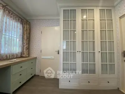 Charming bedroom with elegant built-in wardrobe and natural light