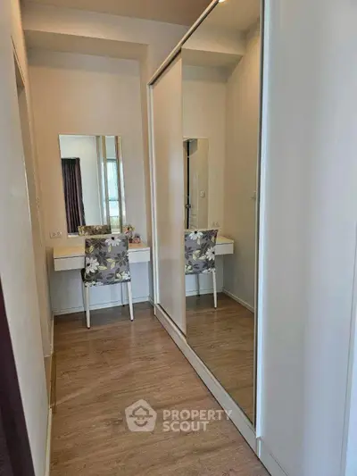 Stylish bedroom with mirrored wardrobe and elegant vanity setup