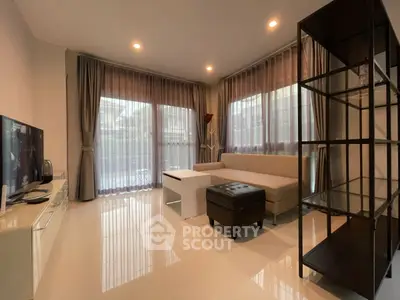 Elegant living room with modern furniture and large windows for natural light.
