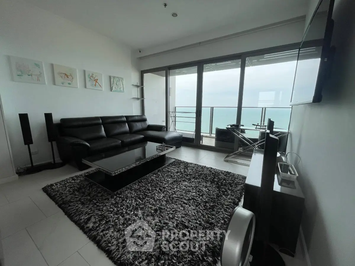 Modern living room with ocean view and sleek black furniture