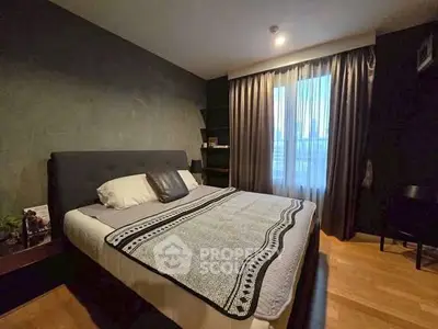 Cozy bedroom with modern decor and large window for natural light.