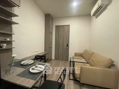 Modern compact living room with dining area and air conditioning in a cozy apartment.